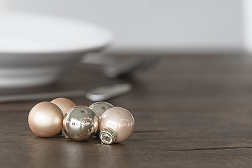 Image showing Christmas baubles in elegant colors on a dinner table