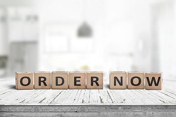 Image showing Order now sign on a wooden table