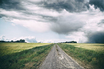 Image showing Rural landscape with dark clouds over a countyside