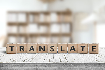 Image showing Translate message on a desk in a bright living room