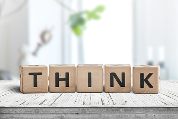 Image showing Think message sign on a worn table