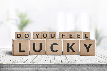 Image showing Do you feel lucky sign on a wooden table