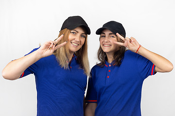 Image showing Portrait of two different-aged girls, in the same clothes