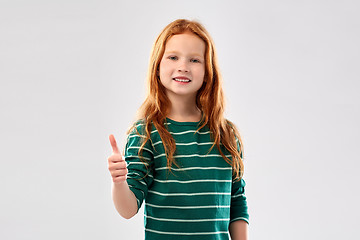 Image showing smiling red haired girl showing thumbs up