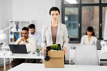 Image showing female office worker with box of personal stuff