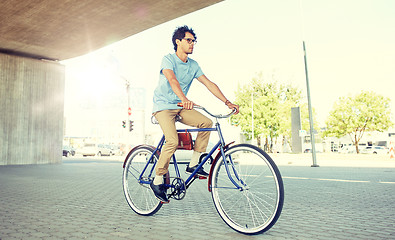 Image showing young hipster man riding fixed gear bike