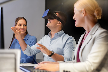 Image showing business team with computer working late at office