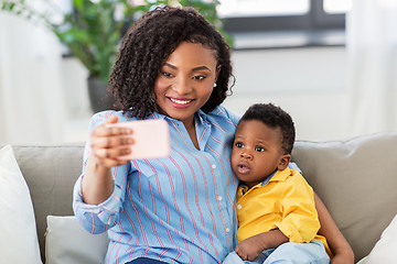 Image showing african mother with baby son taking selfie at home