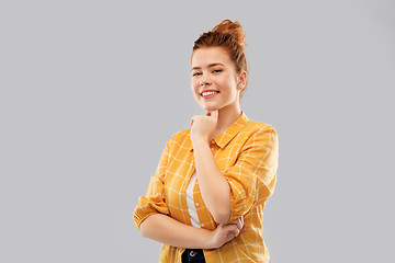 Image showing smiling red haired teenage girl in checkered shirt