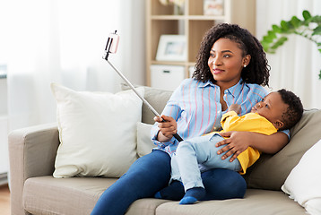 Image showing african mother with baby son taking selfie at home