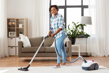 Image showing woman or housewife with vacuum cleaner at home