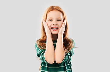 Image showing smiling red haired girl in striped shirt