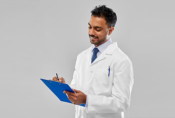 Image showing smiling indian doctor or scientist with clipboard