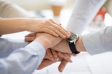 Image showing close up of business team stacking hands