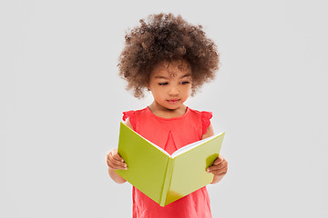 Image showing sad little african american girl reading book