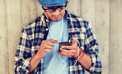 Image showing man with earphones and smartphone listening music