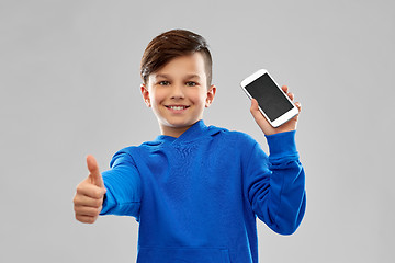 Image showing smiling boy showing smartphone and thumbs up