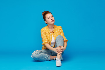 Image showing red haired teenage girl in shirt and torn jeans