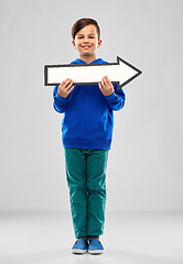 Image showing boy holding big white rightwards thick arrow