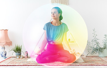 Image showing woman meditating in lotus pose at yoga studio