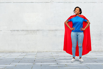 Image showing happy african american woman in superhero red cape