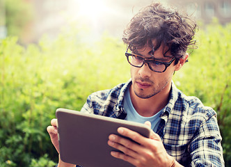 Image showing man in glasses with tablet pc computer outdoors