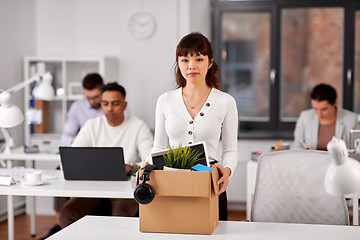 Image showing female office worker with box of personal stuff