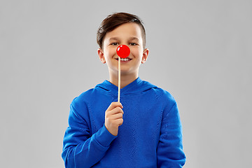 Image showing smiling boy in blue hoodie with red clown nose