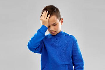 Image showing sick boy in slue hoodie suffering from headache