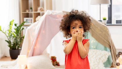 Image showing confused african american girl covering mouth