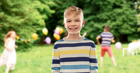 Image showing smiling boy at birthday party in summer park