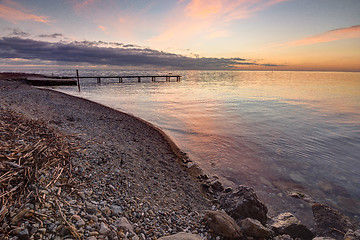 Image showing Beautiful evening sunset at sea, at the far end of the pier