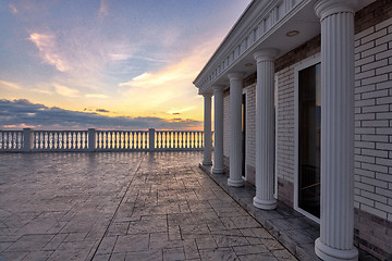 Image showing Beautiful building with columns on a landscaped promenade at sunset