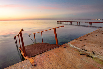 Image showing Seascape, staircase descends into the sea, on the far side of the pier