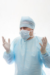 Image showing Surgeon in a sterile gown, mask and gloves shrug isolated on white
