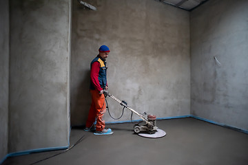 Image showing worker performing and polishing sand and cement screed floor