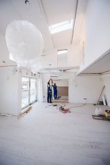 Image showing carpenters installing glass door with a wooden frame