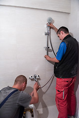 Image showing professional plumbers working in a bathroom