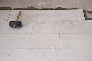 Image showing Ceramic wood effect tiles and tools for tiler on the floor