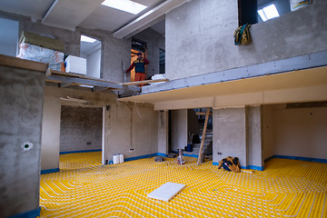 Image showing yellow underfloor heating installation with white pipes