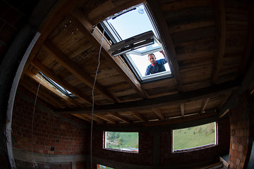 Image showing construction worker installing roof window