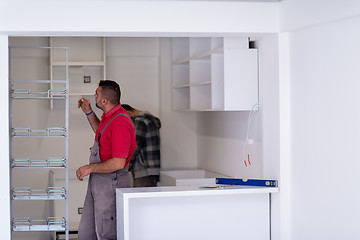 Image showing workers installing a new kitchen