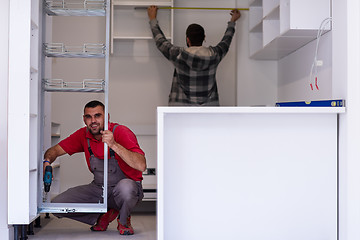 Image showing workers installing a new kitchen