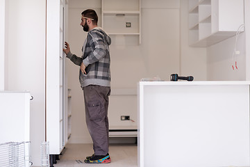 Image showing worker installing a new kitchen