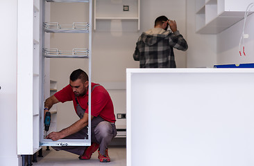 Image showing workers installing a new kitchen