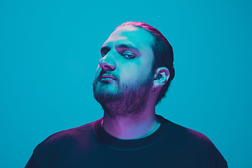 Image showing Portrait of a guy with colorful neon light on blue background - cyberpunk concept