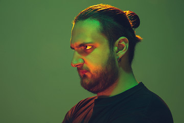 Image showing Portrait of a guy with colorful neon light on green background - cyberpunk concept