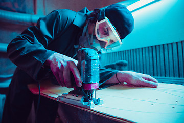 Image showing Skater in process of making his own skateboard, longboard - open business concept