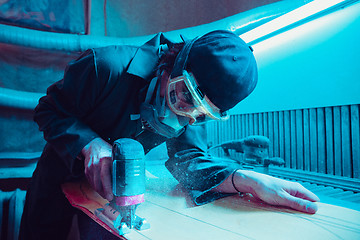Image showing Skater in process of making his own skateboard, longboard - open business concept