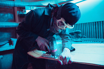 Image showing Skater in process of making his own skateboard, longboard - open business concept